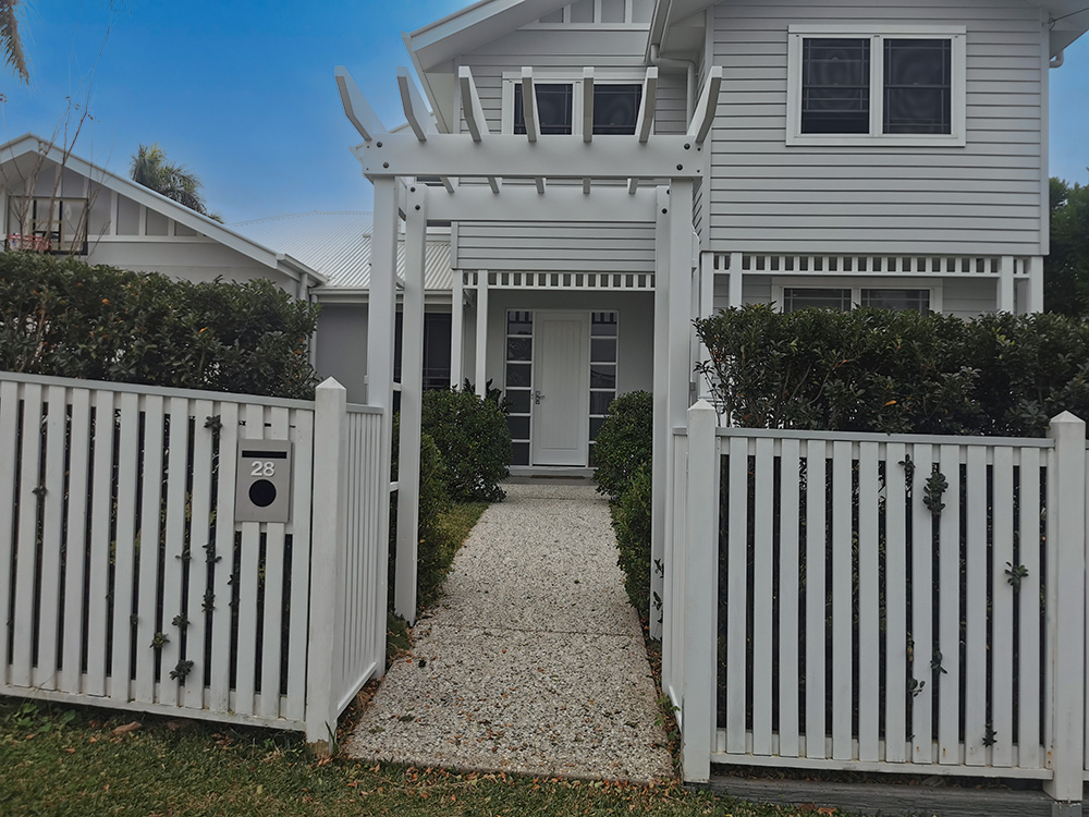 The entrance Arbour creates a lovely pathway through the gate with balustrading added to match the existing fence.