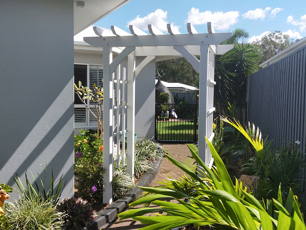 This lovely arbour sits over a pathway leading to the backyard.