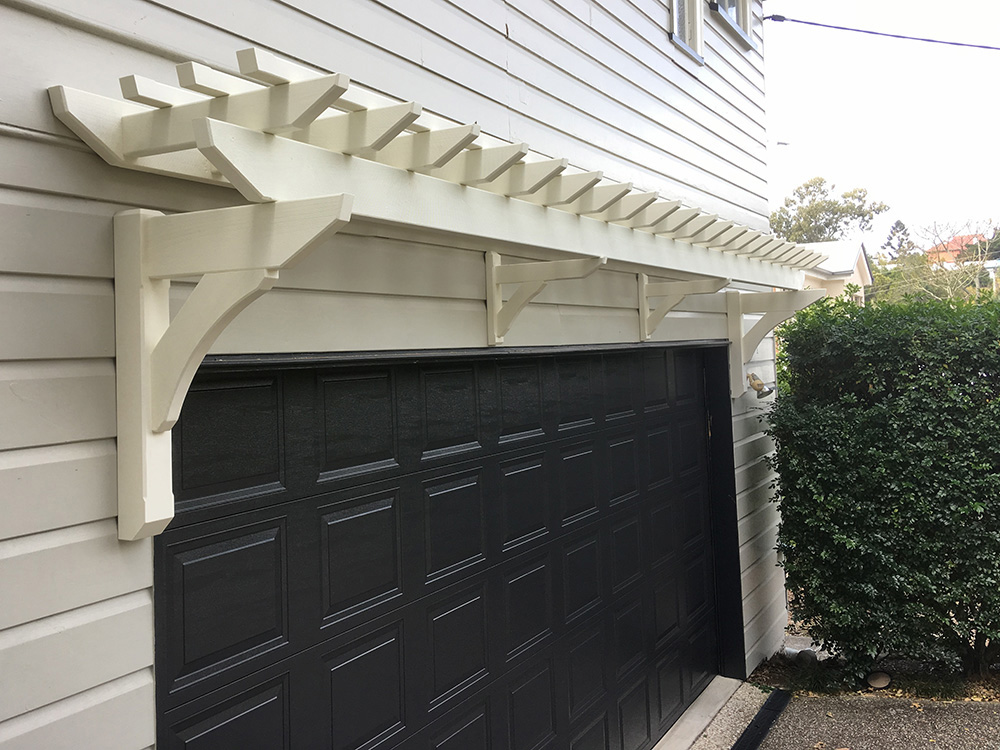 Painted Eyebrow Garage Pergola to match 1915 style Queenslander features and accents. Designed to create a feature for the side of the house above the garage.