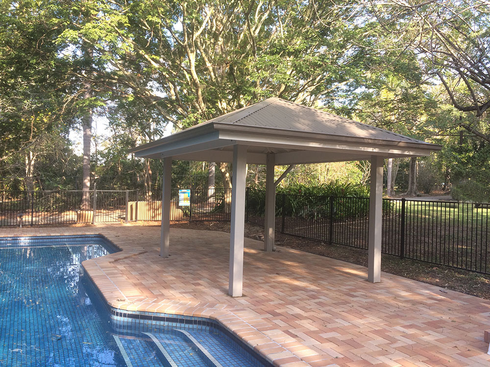 Gazebo set into existing pool surround. Painted Gazebo with hardwood posts concreted in ground.