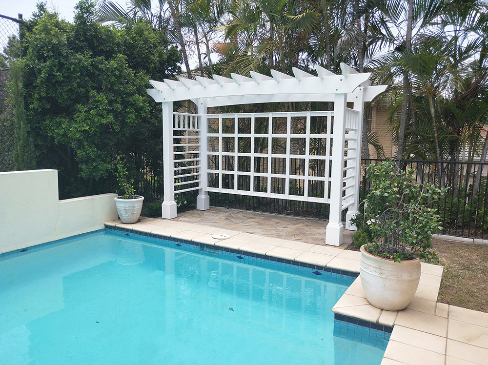 This white Pergola has many features including arched beams, screening and decorative boxes.