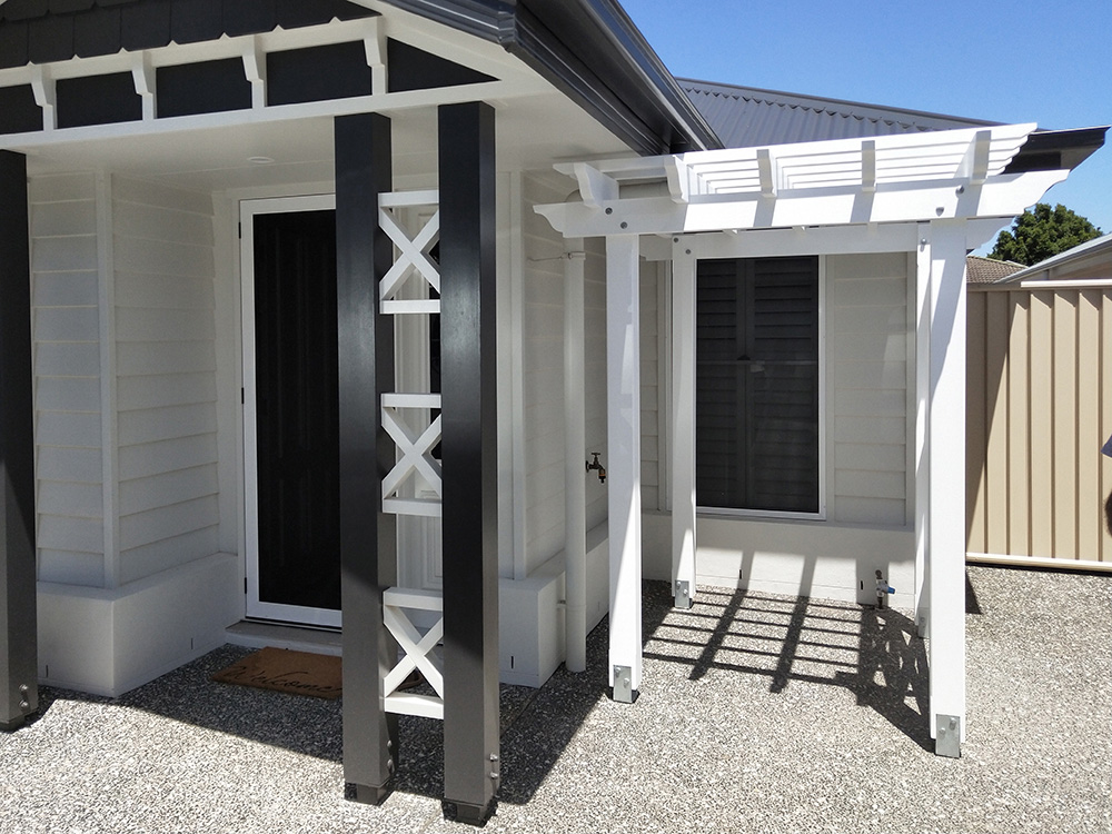 This white Pergola has been set just under the soffit of the residence and the X screening has been made to complement the existing aspect features.