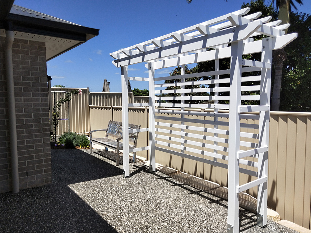 This painted white pergola is set at the back of the residence to provide further depth and added green space once the Pergola has had a flowering vine added.