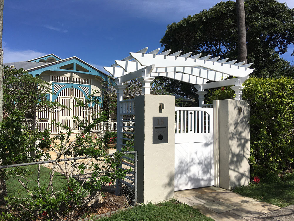 This Pine Entance Arbour has hand-crafted elements to match this heritage house.