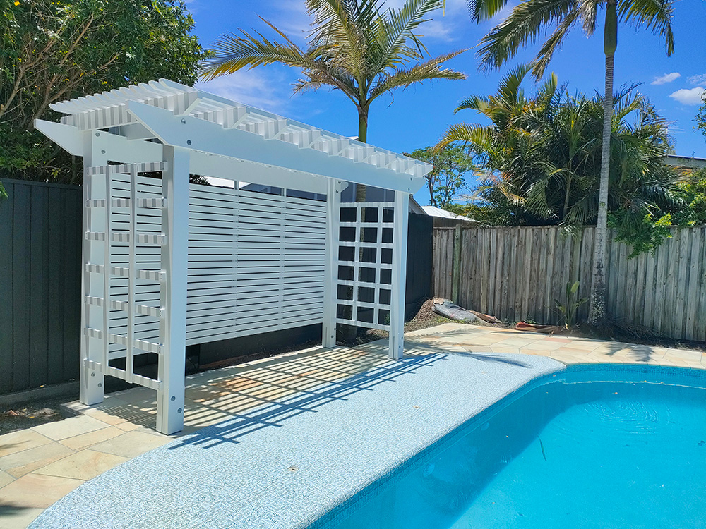 This painted white Pine Pergola creates a lovely new sitting area beside the pool.