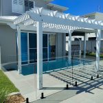 This beautiful White Pergola with the decorative OGEE profile has been set outside a living room. The Pergola will provide additional shade for this room.