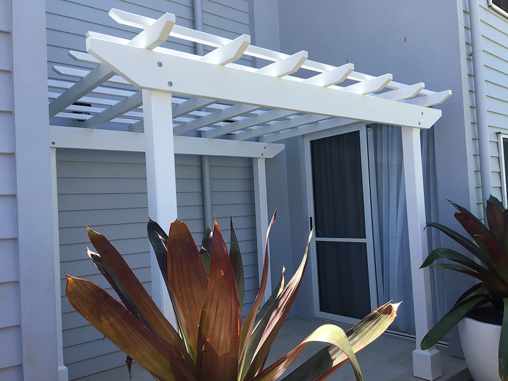 Nestled into this entrance is a new White Painted Pergola.