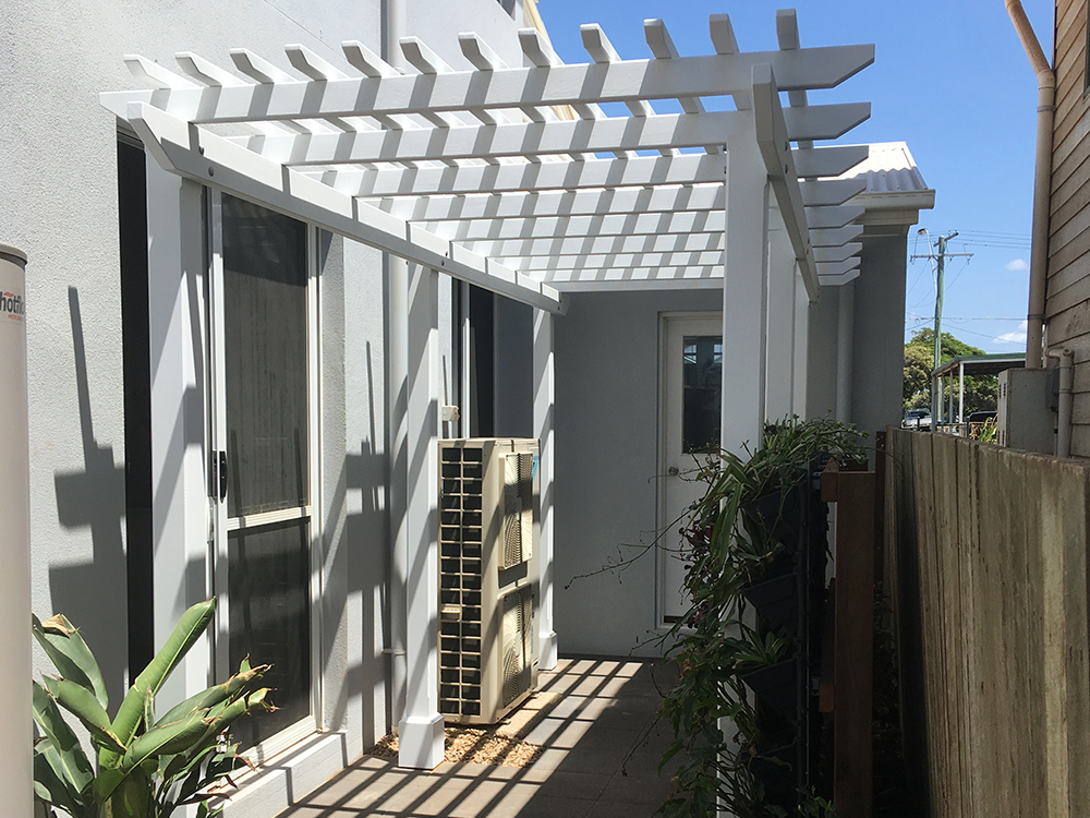 Pine Pergola set into the side entrance, complimenting the new green wall and set into newly paved area.